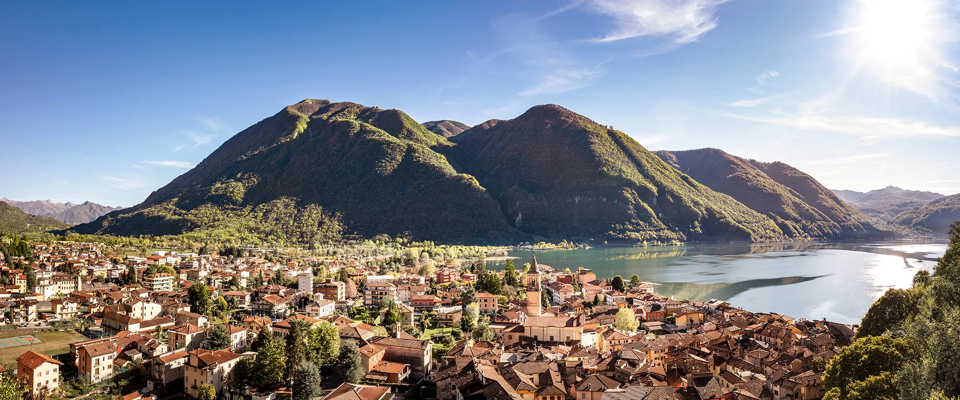Vista panoramica di Porlezza sul Lago di Lugano, contesto ideale per investimenti immobiliari turistici ad alta attrattività.